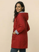 Women's water resistant windbreaker jacket with hood in red and striped inner lining