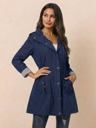 Women's navy blue water resistant windbreaker hooded rain jacket with pockets and adjustable waist
