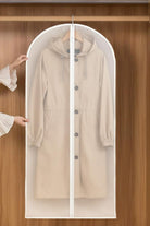 Waterproof dustproof clothing cover protecting beige coat in wooden wardrobe with zipper opening