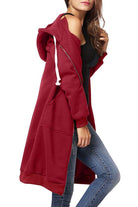 Woman wearing oversized long zip sweatshirt hoodie in red with front pockets and drawstring hood