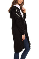 Black oversized long zip sweatshirt hoodie with fleece lining and drawstring hood worn by woman.