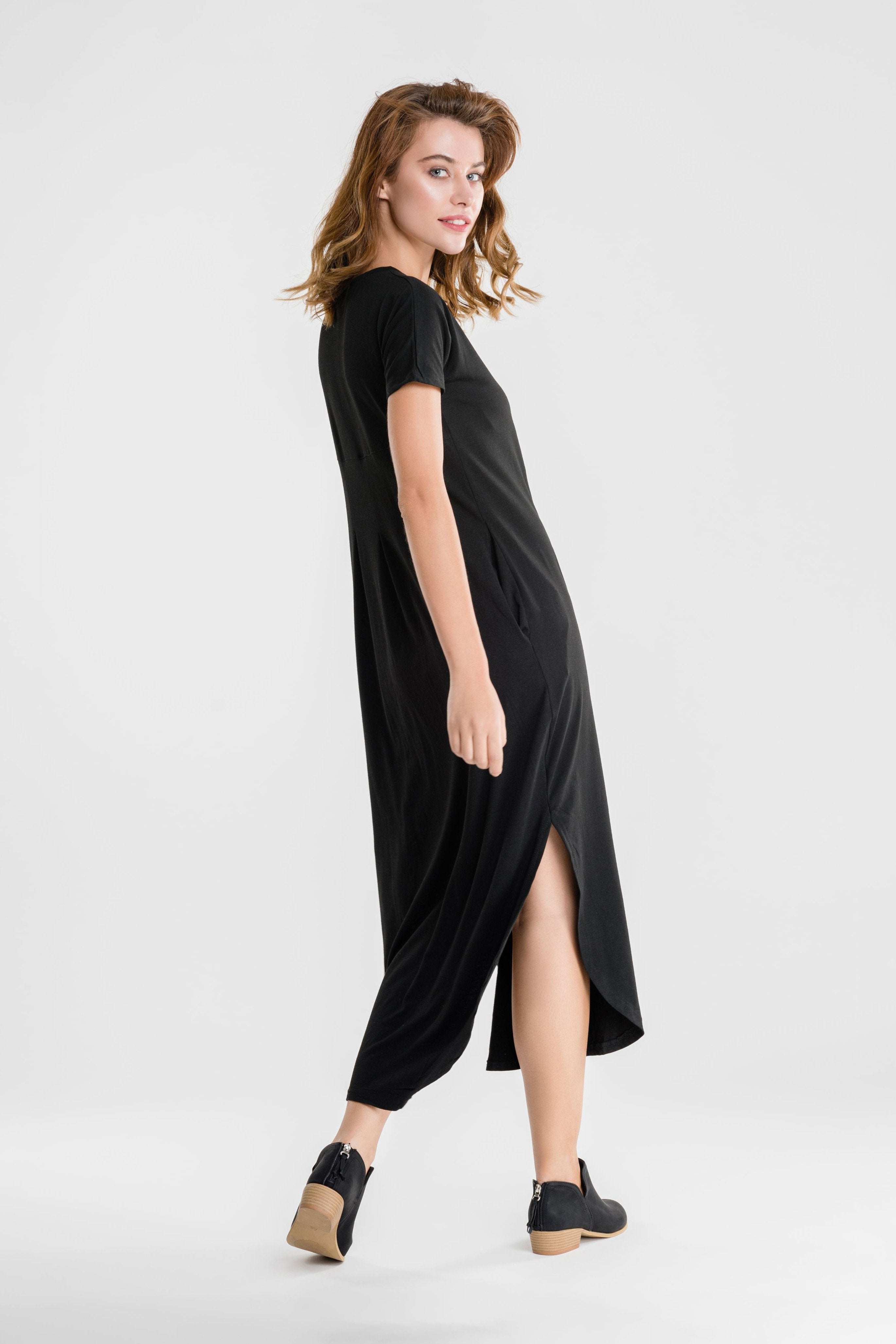 Woman wearing black side slit maxi dress with pockets and short sleeves